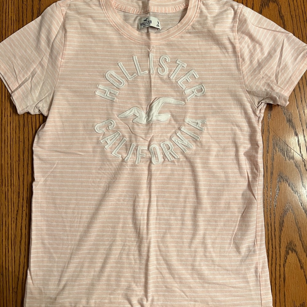 Hollister women’s medium pink and white striped logo tee